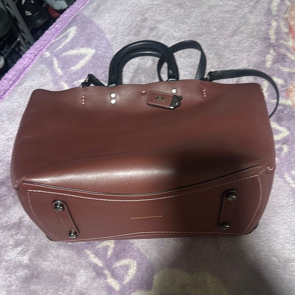 Coach rogue 
Dark maroon color
Alittle corner damage 
Not noticeable